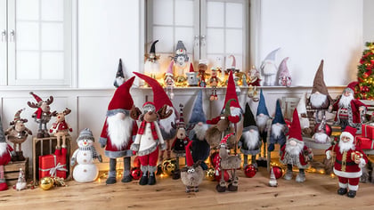Eine große Sammlung festlicher Weihnachtsdekorationen mit zahlreichen Wichteln, Rentieren und anderen Weihnachtsfiguren in einer Ausstellung.