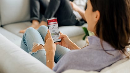 Person durchsucht die Bauhaus-App auf einem Smartphone nach Fenster-Sonnenschutz. Der Bildschirm zeigt Produktkategorien und Suchoptionen.