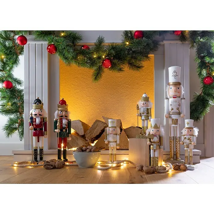 Weihnachtsgirlande Glendon - Kunststoff, LED-Beleuchtung - Weihnachtliche Szene mit einer Sammlung von Nussknackern in verschiedenen Farben und Designs vor einem dekorierten Kamin.