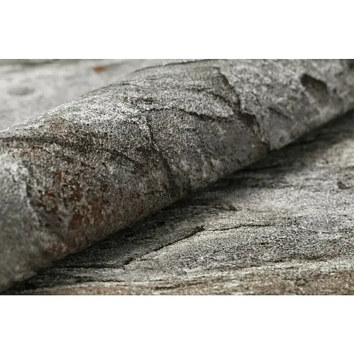 Rasch Vliestapete Bruchstein - Rot/Grau, Steinoptik, 10,05 x 0,53 m - Nahaufnahme einer grauen Steintextur mit erhabenen Details, die eine robuste und natürliche Oberfläche zeigt.