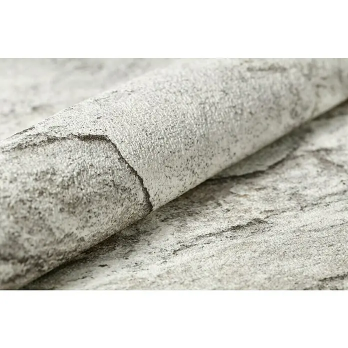Rasch Vliestapete Bruchstein - Grau/Rostbraun, Steinoptik, 10,05 x 0,53 m - Nahaufnahme einer gerollten Tapete mit einem Muster, das an eine Steinmauer erinnert. Die Textur der Tapete ist deutlich sichtbar.