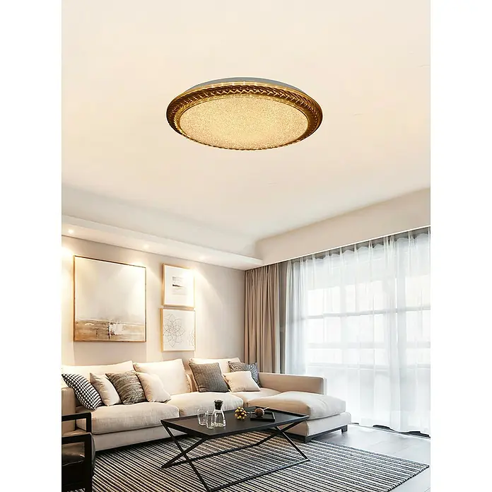 Tween Light LED-Deckenleuchte Ferrada - 24 W - Nahaufnahme einer modernen runden Deckenleuchte mit goldenem Rand in einem stilvollen Wohnzimmer, die für eine angenehme Beleuchtung sorgt.
