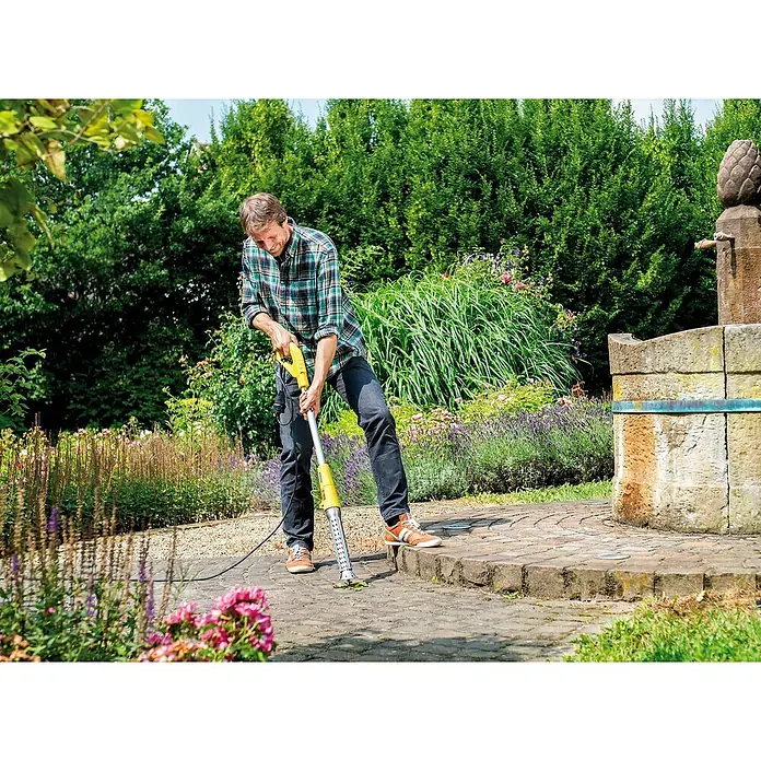 Gloria Unkrautvernichter Thermoflamm bio Electro - 2.000 W, Flammtemperatur: 650 °C - Ein Mann benutzt einen gelben Kärcher-Gerät zur Wildkrautentfernung auf einem gepflasterten Weg in einem Garten.