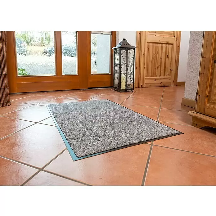 Astra Schmutzfangmatte Proper Tex - Grau, 60 x 180 cm, Material Nutzschicht: 100 % Polyamid - Graue melierte Fußmatte mit schwarzem Rand auf Fliesenboden im Eingangsbereich.