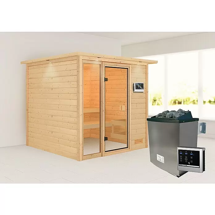 Karibu Massivholzsauna Jutta - L x B x H: 210 x 224 x 191 cm, Mit 9 kW Ofen mit externer Steuerung, Mit Dachkranz und Beleuchtung - Eine helle Holzsaunakabine mit Glastür und externem Bedienfeld, daneben ein Edelstahl-Saunaofen mit Steinen, in einem Innenraum.