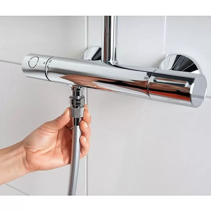 Puregreen Wassersparverschraubung - Geeignet für: Brausearmaturen, Chrom - Hand verbindet silbernen Brauseschlauch mit verchromtem Thermostat-Duschmischer.