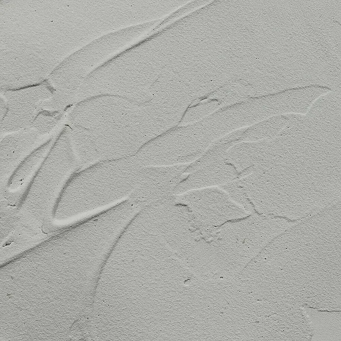 Talens Art Creation Pasta de color Beton - 100 ml, Gris piedra - Primer plano de una superficie gris texturizada que muestra patrones irregulares similares a manchas, creando una textura artística y moderna.