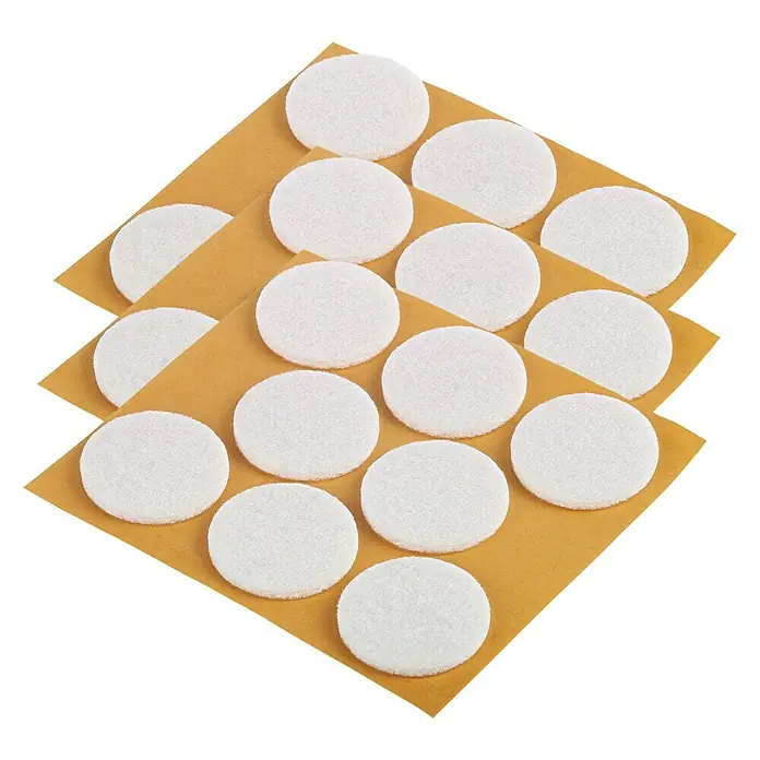 Fix-o-moll Filzgleiter - Durchmesser: 28 mm, Kleben, 24 Stk., Weiß - Nahaufnahme von Möbelgleitern auf Bögen, die sich ideal zum Schutz von Böden vor Kratzern eignen.