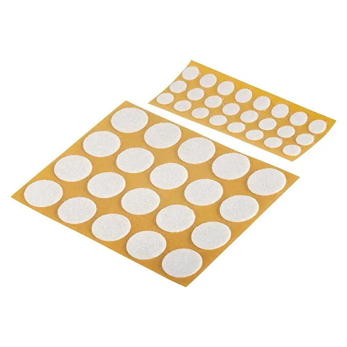 Suki Patín antideslizante para alfombras - Diámetro: 10 mm, Blanco, Pegado, 44 pzs. - La imagen muestra dos láminas de fieltros autoadhesivos en varios tamaños, ideales para proteger los muebles de los arañazos.