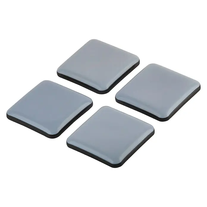Suki Protector para muebles - An x L: 40 x 40 mm, Gris - Primer plano de cuatro deslizadores cuadrados de muebles grises con un borde negro sobre un fondo negro.