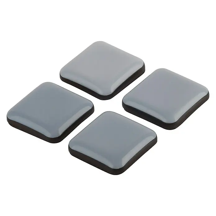 Suki Patín antideslizante para alfombras - An x L: 30 x 30 mm, Diámetro: 30 mm, Gris, 4 ud. - Cuatro protectores de fieltro cuadrados grises con un borde negro sobre un fondo negro.