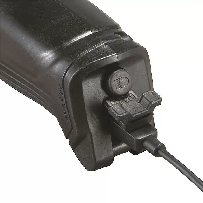 Makita Akku-Knickschrauber DF001DW - 3,6 V, 1 Akku, 4 Nm - Nahaufnahme eines schwarzen Kunststoffgeräts mit Kabel, das in den USB-Ladeanschluss gesteckt ist, neben einem Knopf mit Glühbirnensymbol.