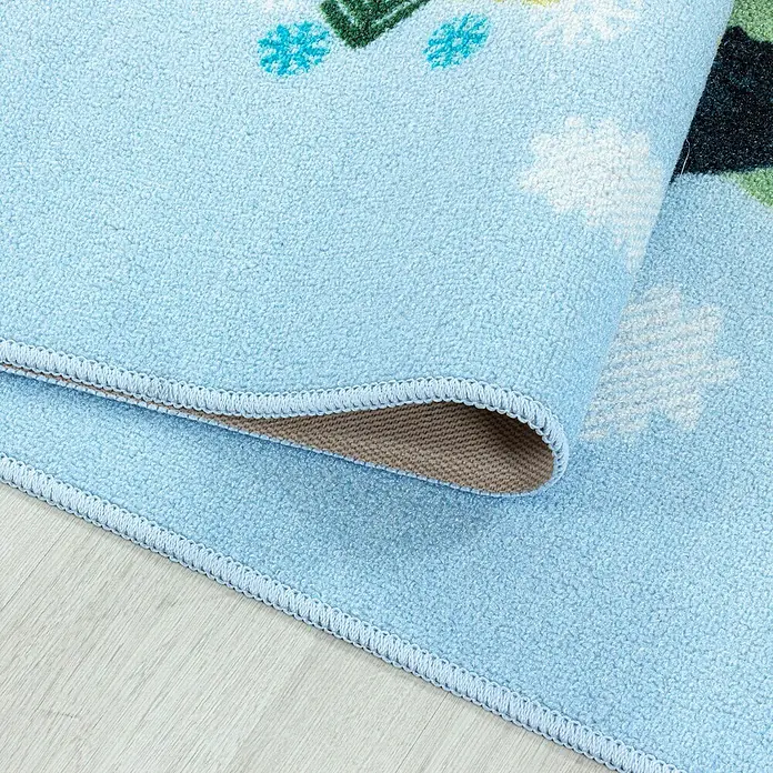 Kinderteppich Play 2917Blau, 230 x 160 cm, 100% Polyamide - Nahaufnahme eines blauen Kinderteppichs mit bunten Mustern und einer dekorativen Kante, der auf einem hellen Holzboden liegt.