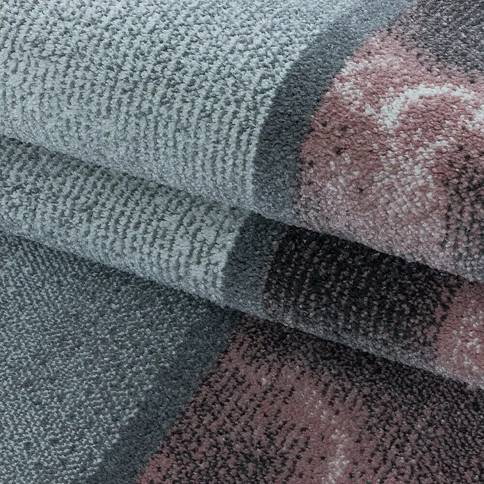 Kurzflorteppich Ottawa 4201 - Rose, 200 x 140 cm, 100% Polypropylen - Nahaufnahme eines grauen Teppichs mit rosa und dunkleren Akzenten, der eine weiche und strukturierte Oberfläche zeigt.