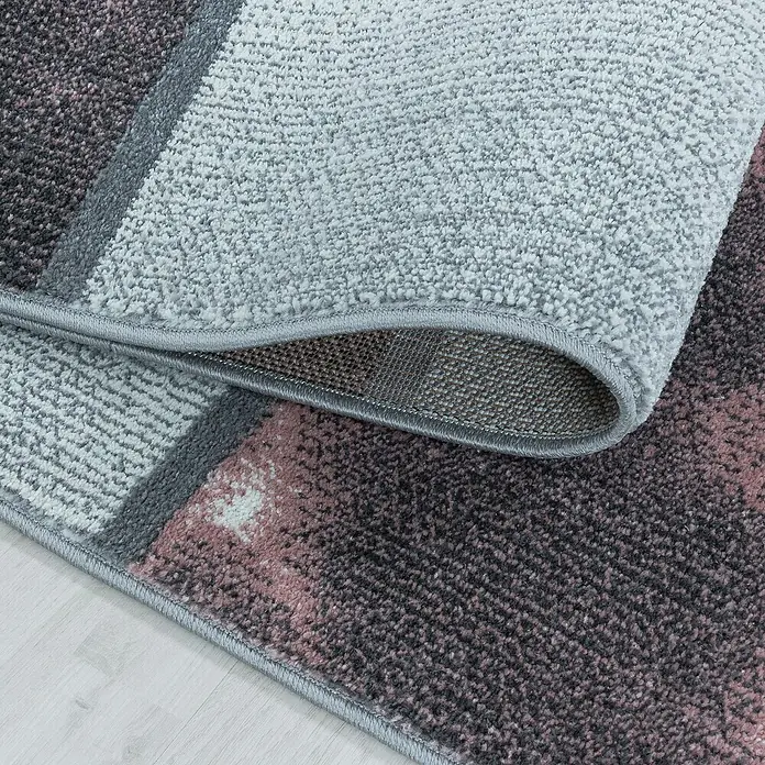 Kurzflorteppich Ottawa 4201 - Rose, 200 x 140 cm, 100% Polypropylen - Nahaufnahme eines modernen Teppichs mit abstraktem Muster in Grau- und Rosatönen, der eine stilvolle und gemütliche Atmosphäre schafft.