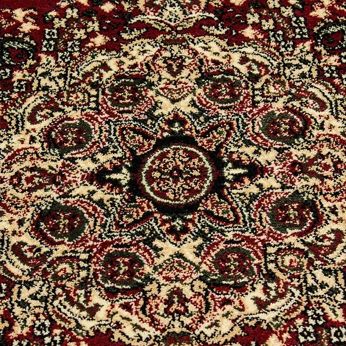 Kurzflorteppich Orient-Optik Marrakesh 0297 - Rot, 290 x 200 cm, 100% Polypropylen - Nahaufnahme eines detailreichen Teppichs mit einem komplexen Muster in Rot, Beige und Schwarz, das traditionelle Motive zeigt.