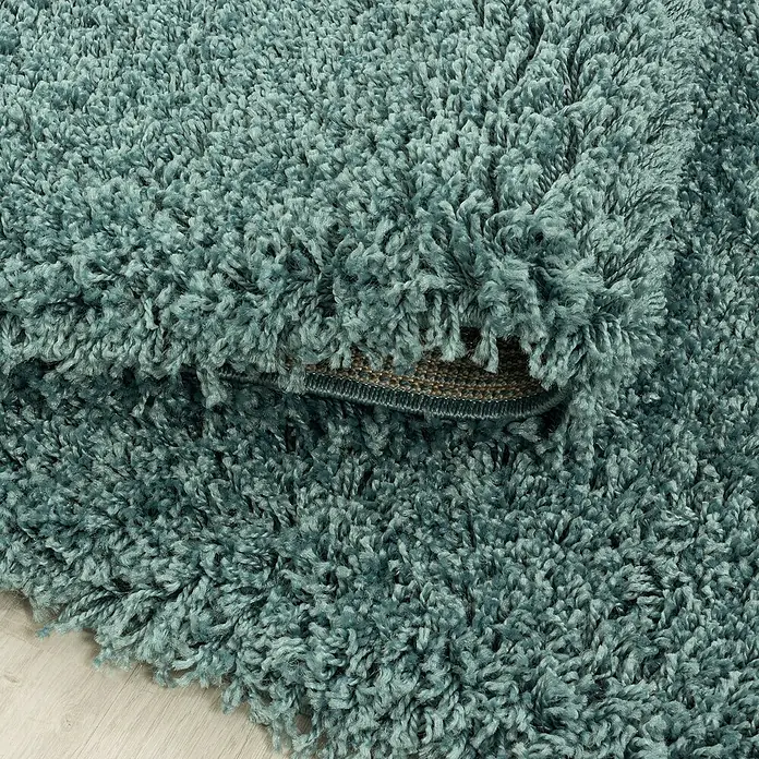 Hochflorteppich Sydney 3000Aqua, 170 x 120 cm, 100 % Polypropylen - Nahaufnahme eines türkisfarbenen Shaggy-Teppichs, der eine weiche und luxuriöse Textur zeigt. Ideal für Wohnzimmer oder Schlafzimmer.