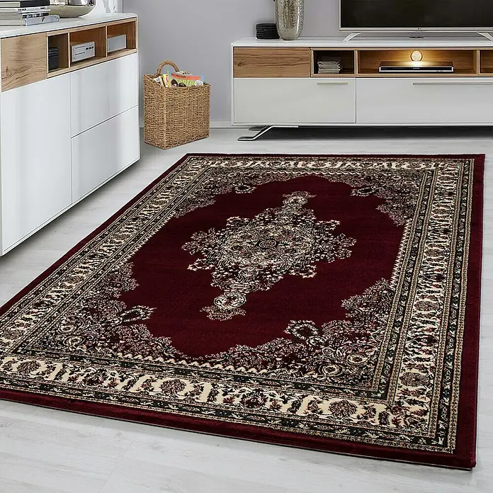 Kurzflorteppich Orient-Optik Marrakesh 0297 - Rot, 290 x 200 cm, 100% Polypropylen - Ein rechteckiger, burgunderroter Teppich mit einem aufwendigen, cremefarbenen und schwarzen Bordürenmuster und einem zentralen Medaillon.
