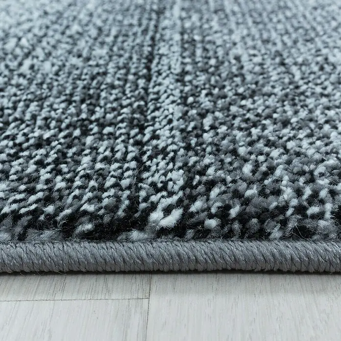 Kurzflorteppich Ottawa 4202 - Grau, 170 x 120 cm, 100 % Polypropylen - Detailaufnahme eines modernen, grauen Teppichs mit melierter Textur, ideal für stilvolle Wohnräume.
