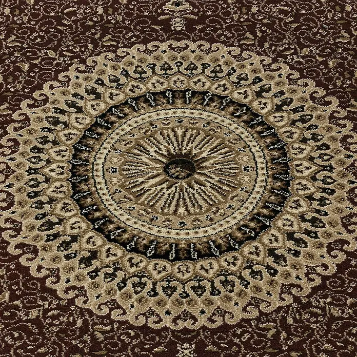 Kurzflorteppich Kashmir 2605Rot, 150 x 80 cm, 100 % Polypropylen - Nahaufnahme eines runden Teppichs mit einem komplizierten, kreisförmigen Medaillonmuster in Braun- und Beigetönen.