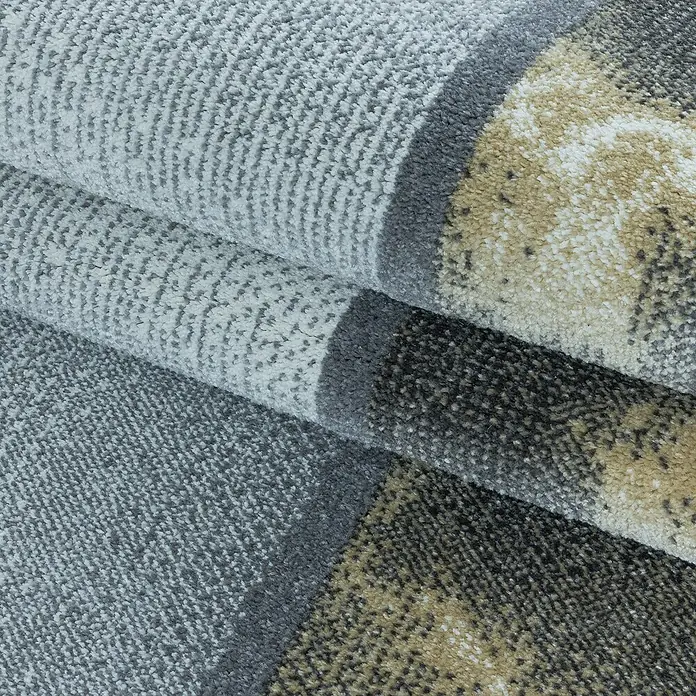 Kurzflorteppich Ottawa 4201 - Gelb, 150 x 80 cm, 100% Polypropylen - Nahaufnahme eines modernen Teppichs mit geometrischem Muster und Farbverläufen in Grau-, Beige- und Brauntönen.