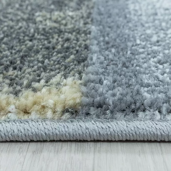 Kurzflorteppich Ottawa 4201 - Gelb, 150 x 80 cm, 100% Polypropylen - Weicher, zotteliger Teppich in Grau und Beige mit geflochtener Kante auf hellem Holzboden.