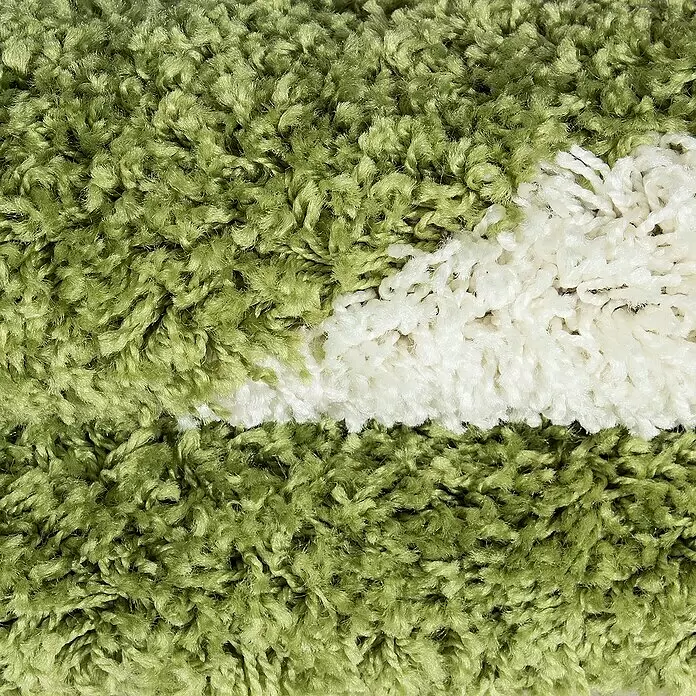 Kinderteppich Fun 6001 - Grün, Durchmesser: 100 cm, 100% Polypropylen - Nahaufnahme eines weichen, zotteligen grünen Teppichs mit einem markanten weißen Streifen.