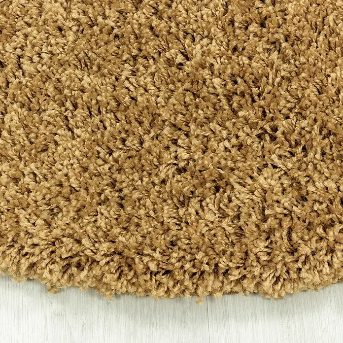 Hochflorteppich Sydney 3000Gold, Durchmesser: 120 cm, 100% Polypropylen - Detailaufnahme eines beigen Shaggy-Teppichs, der eine weiche, flauschige Textur und eine warme Farbpalette zeigt.