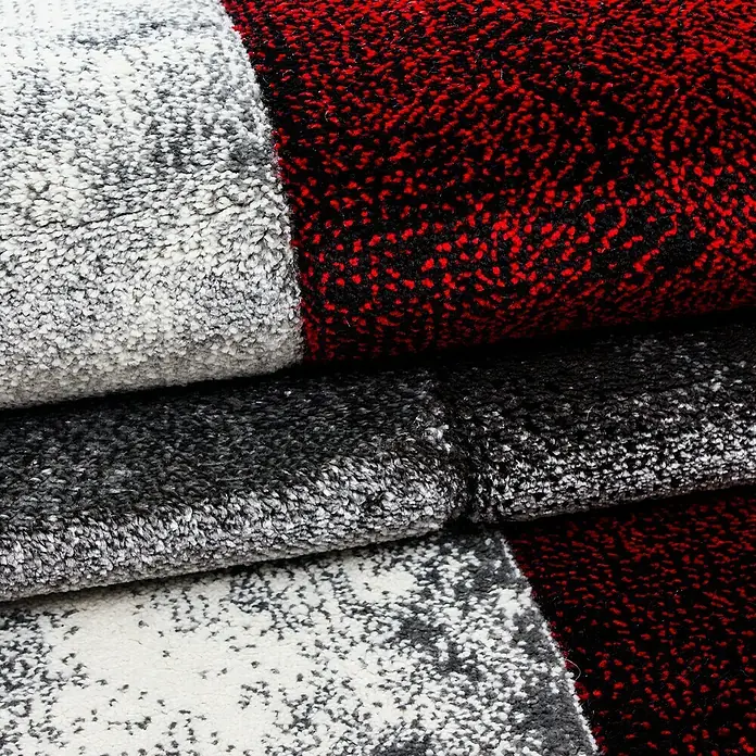 Kurzflorteppich Hawaii 1710 - Rot, 300 x 80 cm, 100% Polypropylen - Detailaufnahme von Teppichmustern in Rot, Weiß und Grau, die eine weiche Textur und hochwertige Verarbeitung zeigen. Ideal für ein gemütliches Zuhause.