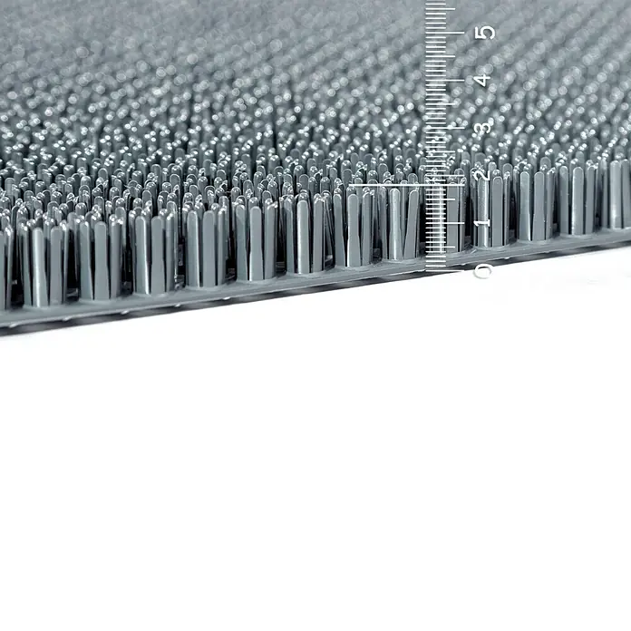 Astra Universalmatte Season - 40 x 60 cm, Grau, Material Nutzschicht: 100 % Polyethylen - Nahaufnahme einer grauen Bürstenmatte mit einer Messskala, die die Höhe der Borsten misst. Die Borsten sind gleichmäßig angeordnet.