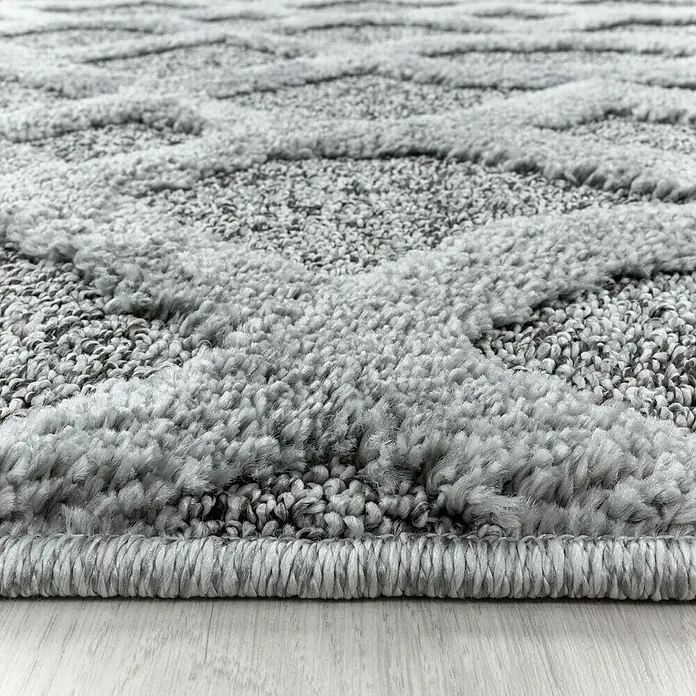 Hochflorteppich Pisa 4702 - Grau, Durchmesser: 200 cm, 100% Polypropylen - Nahaufnahme eines grauen Teppichs mit abstraktem Muster und weicher Textur, ideal für Wohnräume.