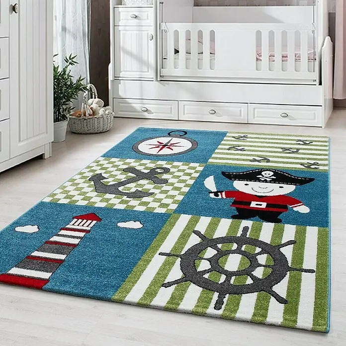 Kinderteppich Kids 0450Multi, 170 x 120 cm, 100% Polypropylen - Ein Teppich mit einem nautischen Piratenmotiv in einem Kinderzimmer. Das Teppichdesign umfasst Kompass, Anker, Leuchtturm und Piraten.