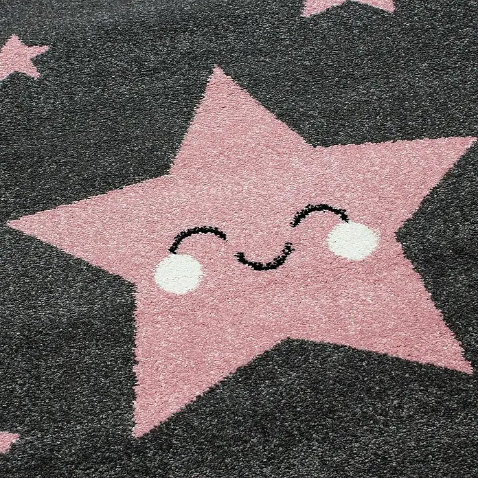 Kinderteppich Kids 0610 - Pink, 150 x 80 cm, 100% Polypropylen - Nahaufnahme eines Teppichs mit einem rosa Stern mit einem lächelnden Gesicht auf einem grauen Hintergrund.