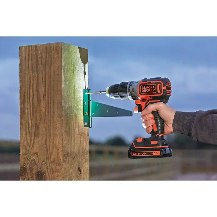 Black+Decker Akku-Schlagschrauber BL188N-XJ - 18 V, Ohne Akku - Nahaufnahme eines Black+Decker Akku-Bohrschraubers, der eine Schraube in ein Holzstück schraubt, mit Fokus auf das Werkzeug und seine Verwendung.