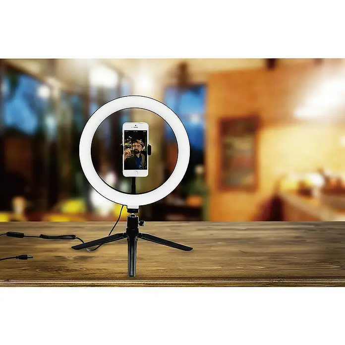 Voltomat Smartphone-Halter Selfie Ring Light - Weiß, USB A-Stecker - Nahaufnahme eines LED-Ringlicht-Selfie-Stativs mit einem Smartphone, das auf einem Holztisch steht.