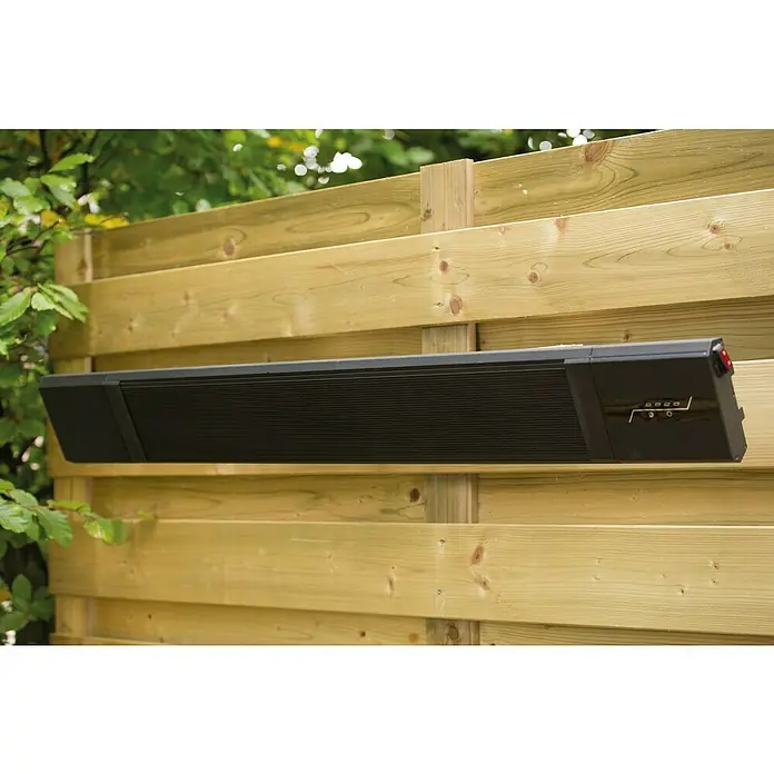 Sunred Heizstrahler Nero - 2.400 W, Schwarz, Breite: 116 cm - Eine montierte, schwarze Terrassenheizung an einem Holzzaun im Garten. Die Infrarotheizung sorgt für Wärme an kühlen Abenden.