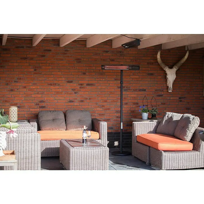 Sunred Heizstrahler Royal Diamond - 2.500 W, Schwarz, Höhe: 210 cm - Terrassenambiente mit Heizstrahler: Gemütliche Sitzgruppe mit Weinflasche und Gläsern vor einer Backsteinmauer.