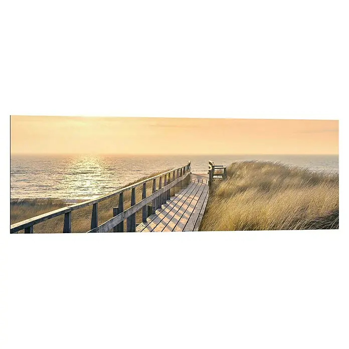 Reinders Decopanel - Way to The Sea, B x H: 90 x 30 cm - Eine Holzbrücke führt über Dünen zum Meer unter einem warmen, goldenen Himmel. Friedliche Küstenlandschaft mit natürlicher Schönheit.