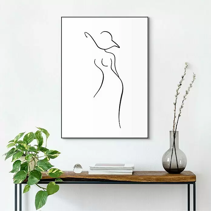 Reinders Bild Slim Frame Black - Pencil I, B x H: 50 x 70 cm - Gerahmter Line-Art-Druck einer Frauensilhouette, an einer Wand über einem Holztisch.