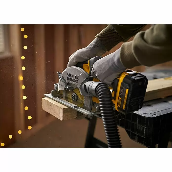 Stanley FatMax Akku-Handkreissäge SFMCS500B-XJ - 18 V, Ohne Akku, 4.000 U/min - Eine Person in Handschuhen verwendet eine gelb-schwarze STANLEY FATMAX V20 Akku-Kreissäge zum Schneiden eines Holzbretts, mit Por Elszívóval.
