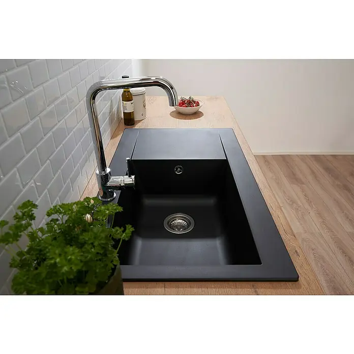 Respekta Einbauspüle Denver - 86 x 50 cm, Schwarz, Anzahl Becken: 1 Stk. - Schwarzes Spülbecken mit Armatur und Holzarbeitsplatte. Eine Topfpflanze steht neben dem Becken.