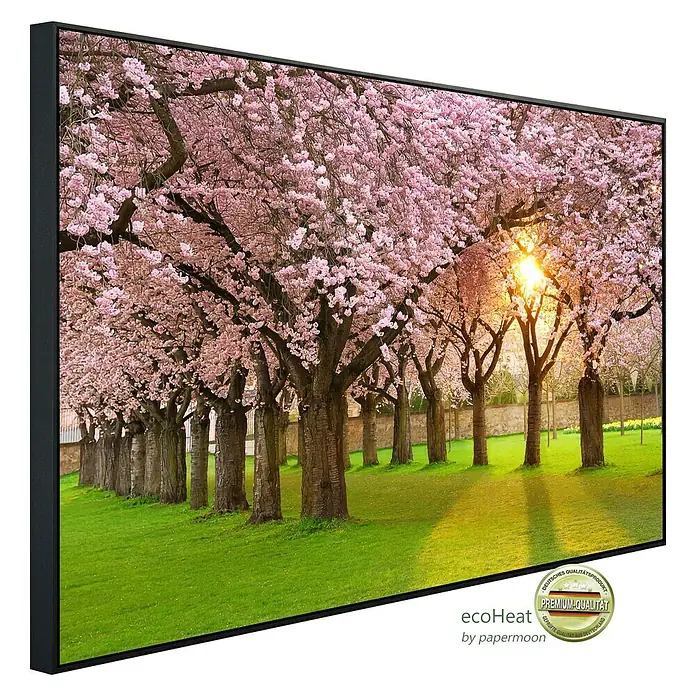 Papermoon Infrarot-Bildheizkörper Kirschbaumgarten - 120 cm x 600 mm, 1.200 W - Das gerahmte Bild zeigt eine Allee von blühenden Kirschbäumen im Sonnenlicht, ein dekoratives Wandbild.
