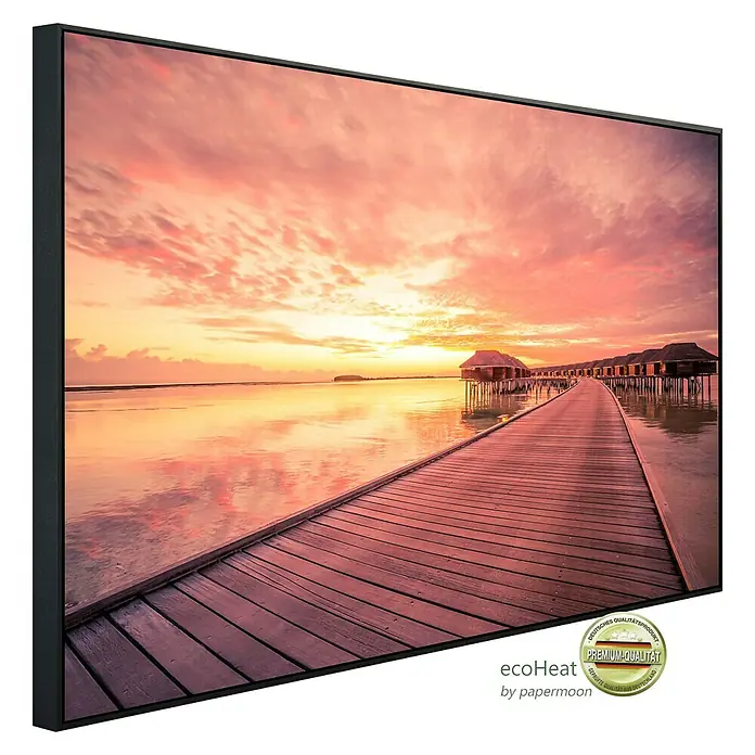 Papermoon Infrarot-Bildheizkörper Wasserbungalows Malediven - 1.200 x 600 mm, 1.200 W - Das gerahmte EcoHeat-Wandbild zeigt einen Steg, der zu Hütten über einem ruhigen Meer bei Sonnenuntergang führt.