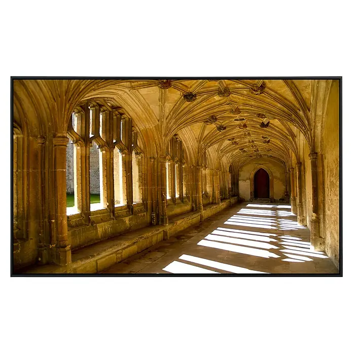 Papermoon Infrarot-Bildheizkörper Sunlit Abbey - 100 cm x 600 mm, 600 W - Detailansicht eines gotischen Kreuzgangs mit eindrucksvollem Gewölbe und Lichtspiel, das die Architektur hervorhebt. Historische Baukunst in Szene gesetzt.