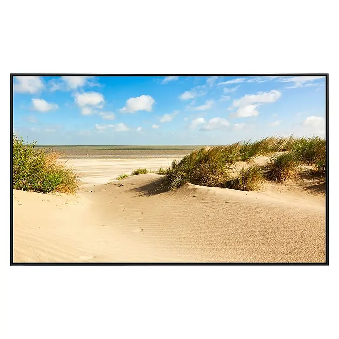 Papermoon Infrarot-Bildheizkörper Dunes Knokkeheist - 120 x 60 cm, 1.200 W - Ein schönes Foto, das in einem modernen schwarzen Rahmen präsentiert wird, zeigt eine friedliche Strandszene mit Sanddünen und blauem Himmel.