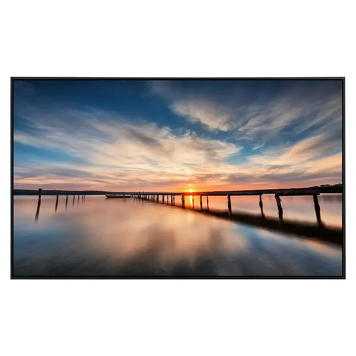 Papermoon Infrarot-Bildheizkörper Lake Sunset Wooden Pier - 100 cm x 600 mm, 800 W - Landschaftsgemälde mit Sonnenuntergang über einem Steg und ruhigem Wasser in einem eleganten schwarzen Rahmen.