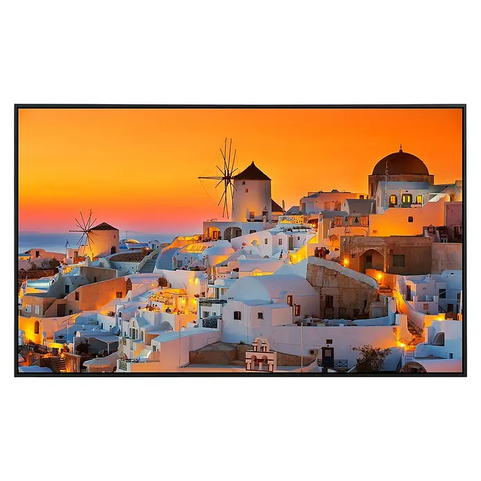 Papermoon Infrarot-Bildheizkörper Santorini Sonnenuntergang 2 - 120 x 60 cm, 1.000 W - Wandbild von Santorini bei Sonnenuntergang, mit Windmühlen und weiß getünchten Häusern, eingefasst in einem schwarzen Rahmen.