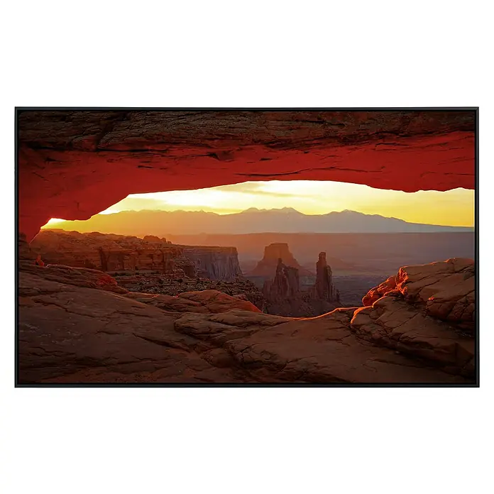 Papermoon Infrarot-Bildheizkörper Herrlicher Sonnenaufgang - 100 x 60 cm, 800 W - Die Leinwand zeigt eine atemberaubende Aussicht auf eine rote Felslandschaft bei Sonnenuntergang, gerahmt von einem schwarzen Rahmen.