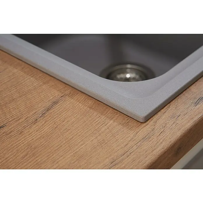 Respekta Einbauspüle Orlando - 86 x 50 cm, Grau - Detailaufnahme eines Spülbeckens aus grauem Verbundmaterial, eingebettet in eine Arbeitsplatte mit Holzstruktur. Praktisches Küchendesign.