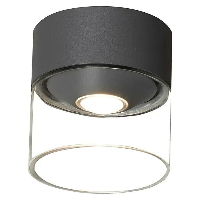 Konstsmide LED-Deckenleuchte Varese - Farbe Gehäuse: Anthrazit, IP54 - Nahaufnahme einer modernen zylindrischen Deckenleuchte mit matter grauer Oberfläche und klarem Glasdiffusor, die ein warmes Licht ausstrahlt.